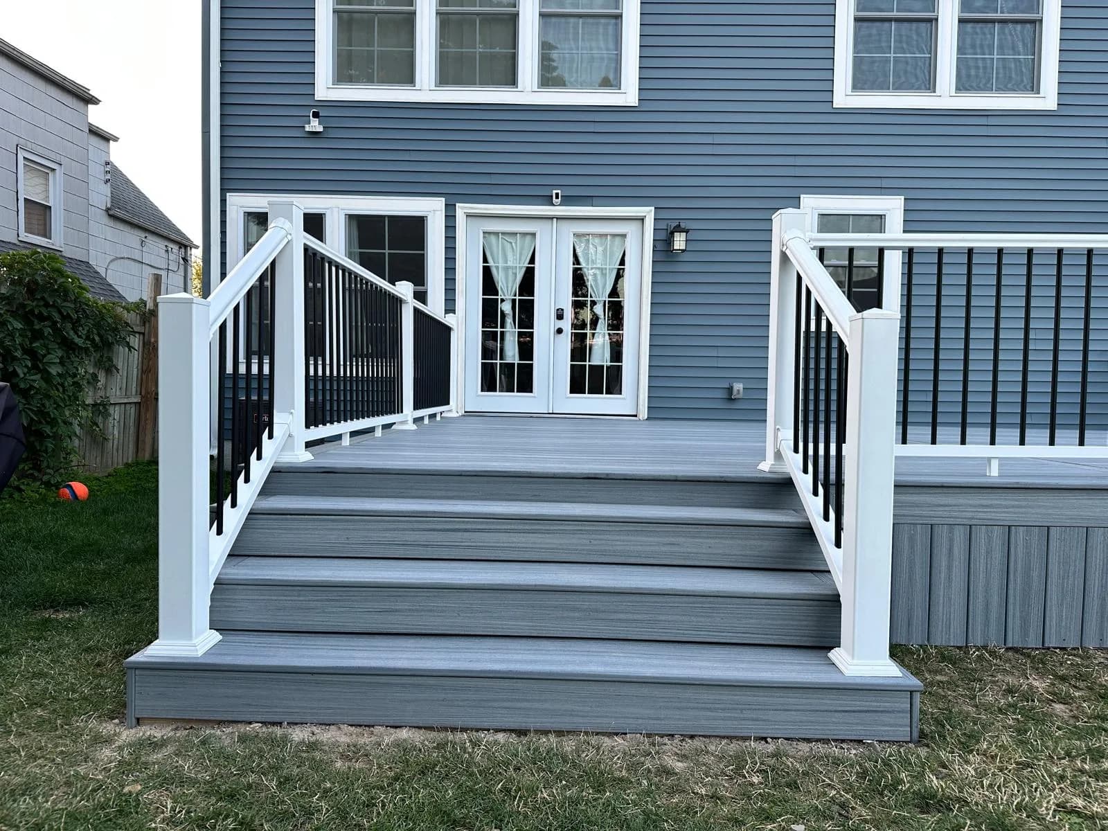 Composite deck staircase with black railing — Buffalo NY