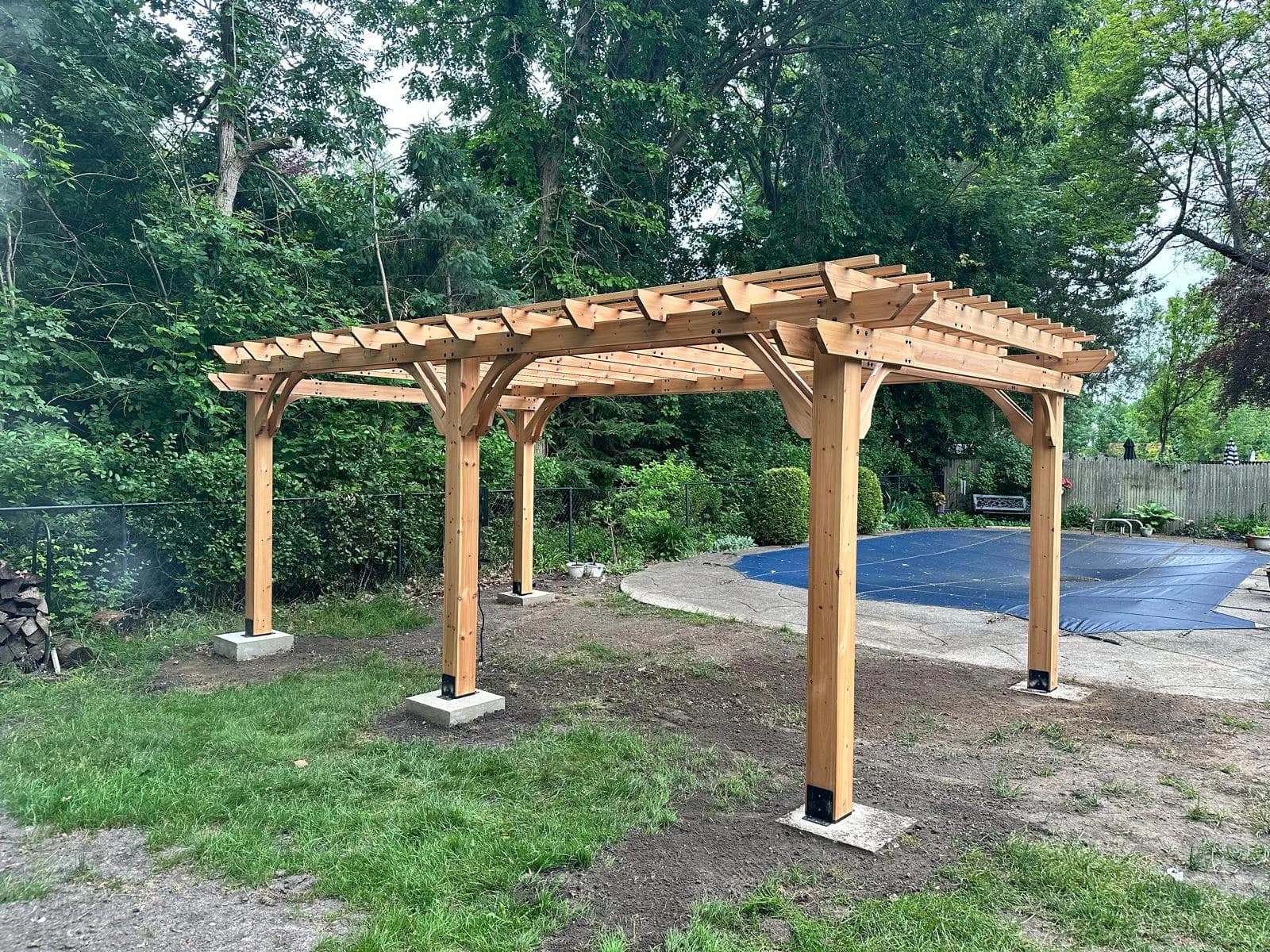 Wood pergola beside pool — Buffalo NY